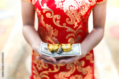 Beautiful asian woman holding dollars or money with lucky pocket money,in the Chinese New Year. Festivities, New Year Celebration  concept.