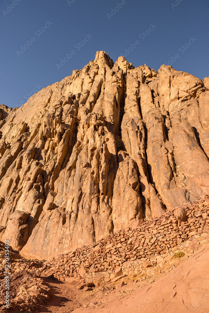 Fototapeta premium Amazing Sunrise at Sinai Mountain, Mount Moses with a Bedouin, Beautiful view from the mountain 