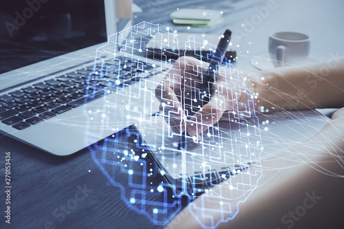 Multi exposure of writing hand on background with brain hologram. Concept of learning.