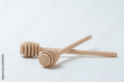 Wooden sticks for honey on a white background	