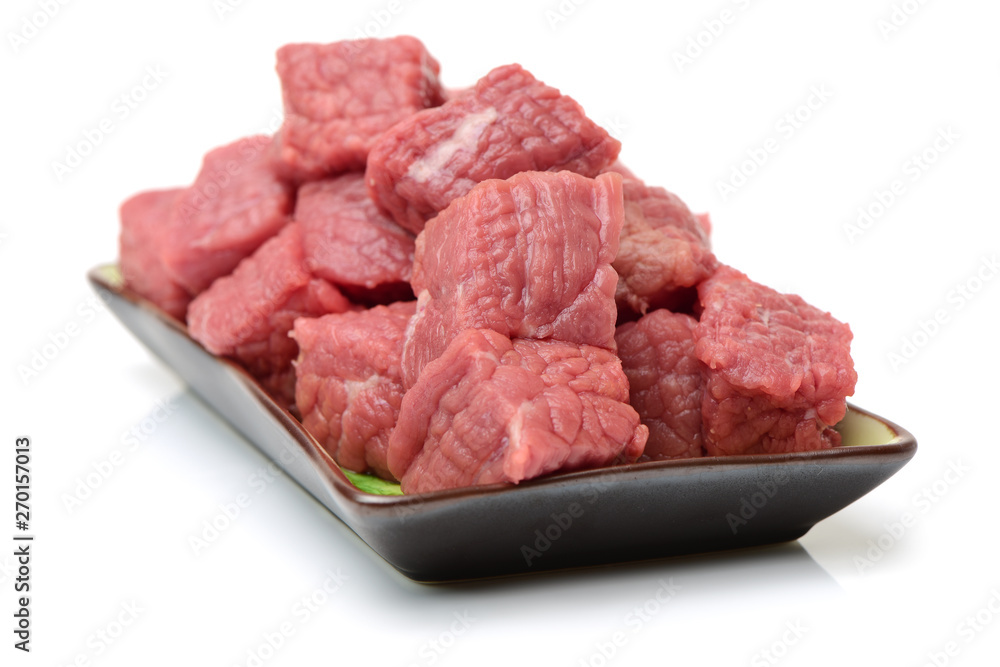 beef cubes with parsley on white background beef cubes with parsley on white background