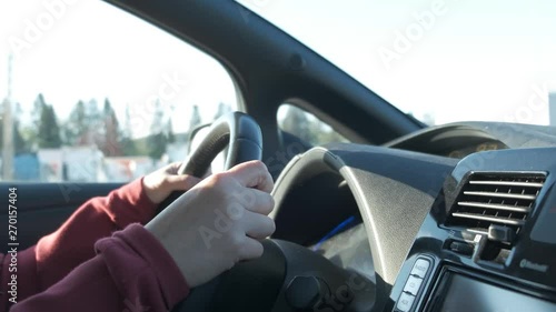 Wallpaper Mural Young man drives a car, his hands are on the steering wheel. Torontodigital.ca