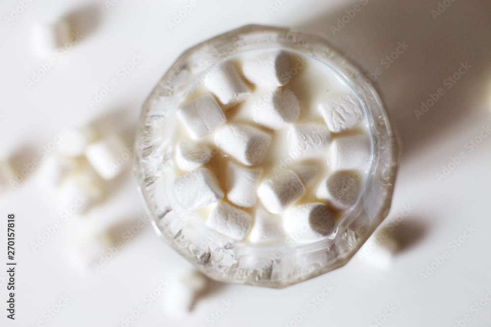 marshmallow in a glass of milk. marshmallows on a white background marshmallow in a glass of milk. marshmallows on a white background