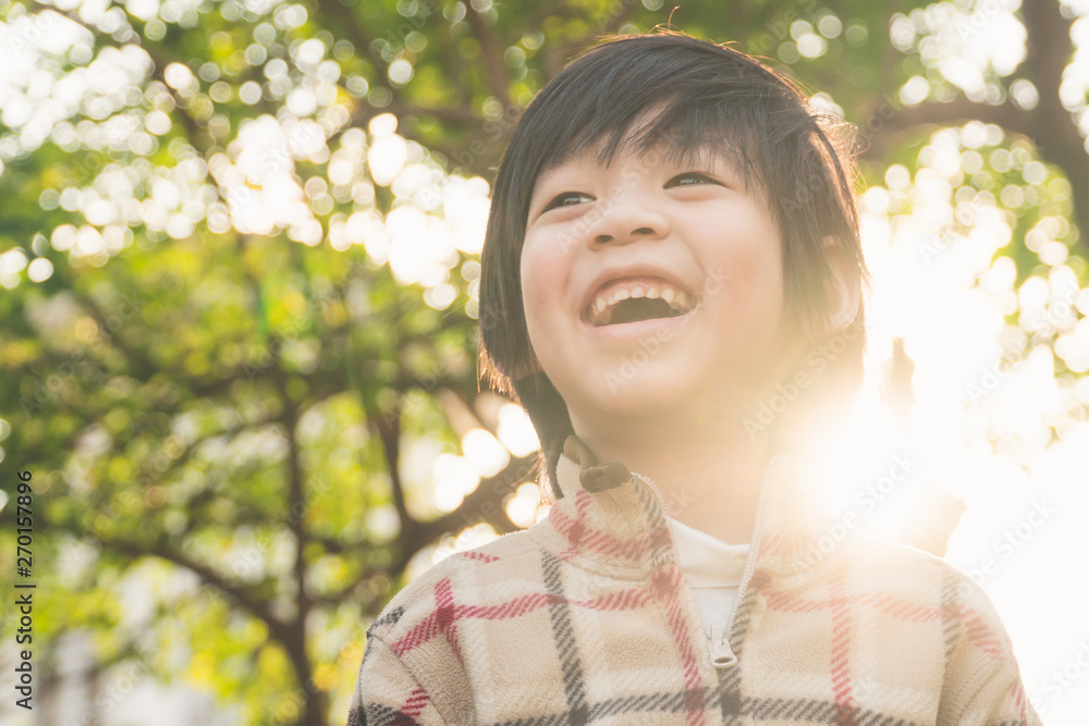 Portrait of happy Asian boy wearing warm clothes smiling in the park Portrait of happy Asian boy wearing warm clothes smiling in the park