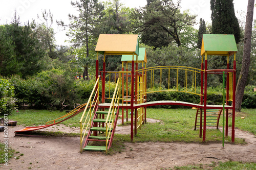 Iron multi colored playground on in the park. In harmony with nature eco-Playground for children