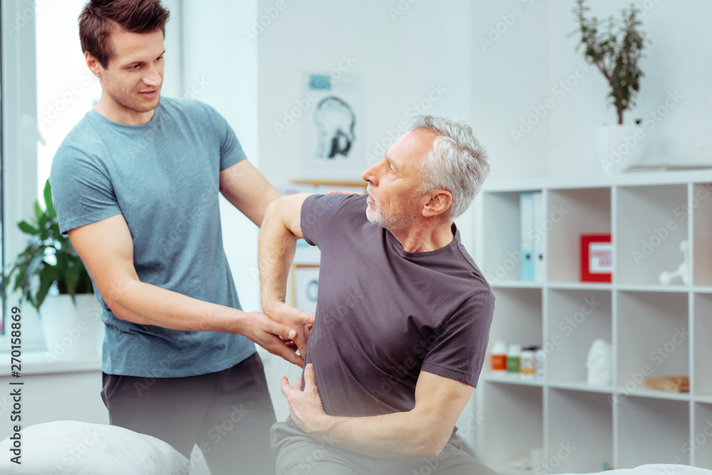 Obraz premium Pleasant senior man showing a painful place