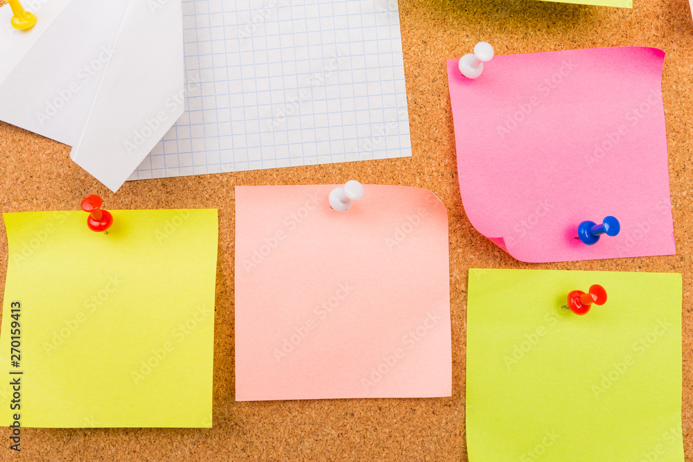 Fototapeta premium Cork board with pinned colored blank notes - Image .