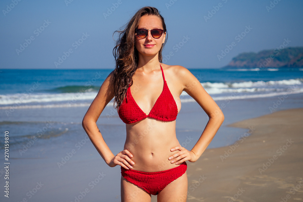 beautiful tanned female fitness big boobs model in a fashion stylish  swimsuit on sea ocean beach blue sky and palm trees background.summer  vacation Stock Photo | Adobe Stock