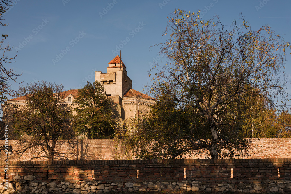 Belgrade, Serbia - November 7, 2018. Belgrade fortress Kalemegdan in golden light, fortification wall with building and trees. Serbian medieval citadel, touristic landmark of Upper and Lower town.