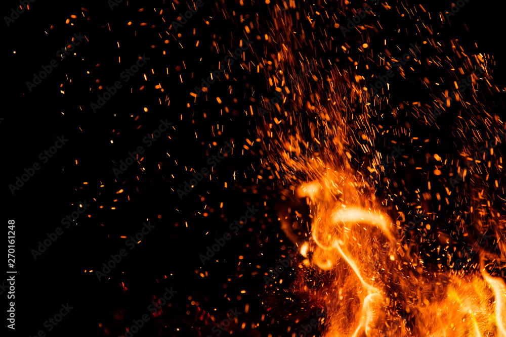 Detail of fire sparks isolated on black background - obrazy, fototapety, plakaty 