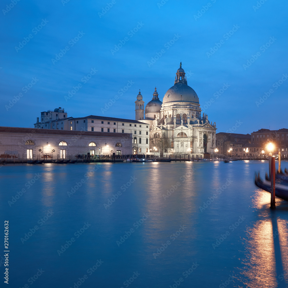 Illuminated church Santa Maria della Salute in the evening, Venice, Italy.