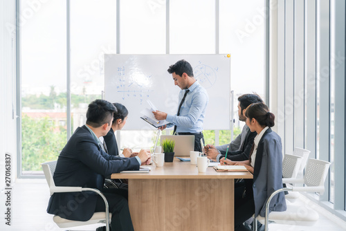 Businesspeople discussing together in conference room during meeting at office.