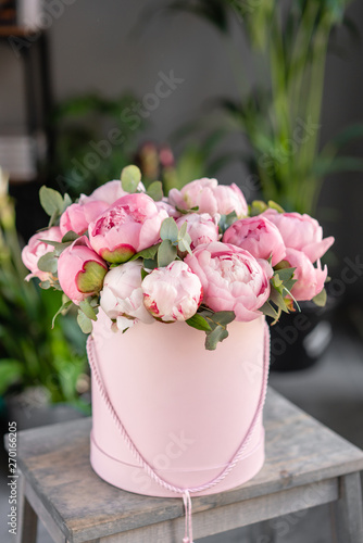Fototapeta Naklejka Na Ścianę i Meble -  Pink peonies on the old grey table. Beautiful peony flower for catalog or online store. Floral shop concept . Beautiful fresh cut bouquet. Flowers delivery
