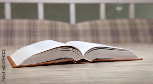Open book on the table on a blurred background