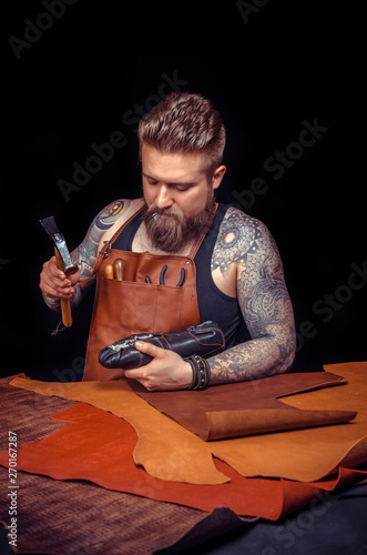 Leather master creates quality product of leather at a workshop photo