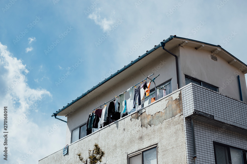 apartment hanging washed clothes in Japan