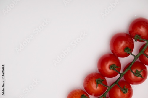 Cherry tomato bunch closeup isolated on white background.