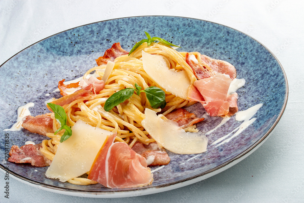 Pasta carbonara with bacon and ham. Italian traditional dish. On a white background Pasta carbonara with bacon and ham. Italian traditional dish. On a white background