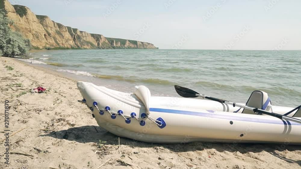 two inflatable boats stand on the beach near river two inflatable boats stand on the beach near river