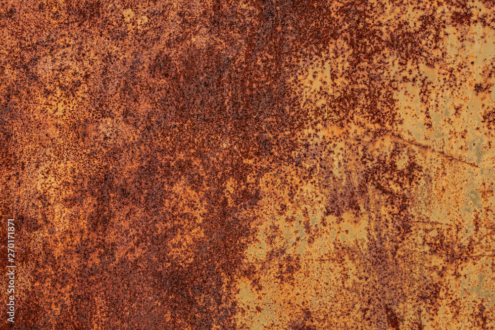 Rusty yellow-red textured metal surface. The texture of the metal sheet is prone to oxidation and corrosion. Textured background in grunge Style Rusty yellow-red textured metal surface. The texture of the metal sheet is prone to oxidation and corrosion. Textured background in grunge Style