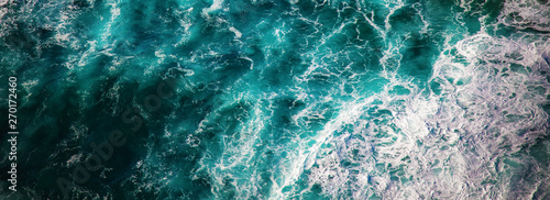 Sea water with foam waves, shot from above abstract natural background and texture