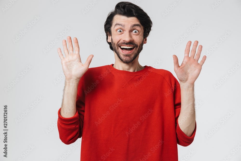 Handsome shocked young man isolated over white wall background. Handsome shocked young man isolated over white wall background.