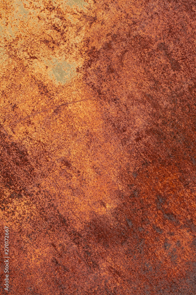 Rusty yellow-red textured metal surface. The texture of the metal sheet is prone to oxidation and corrosion. Textured background in grunge style