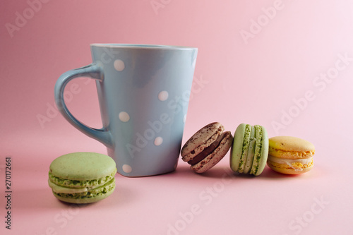  a cup of tea and macaron arranged in a beautiful composition on a pinck background photo