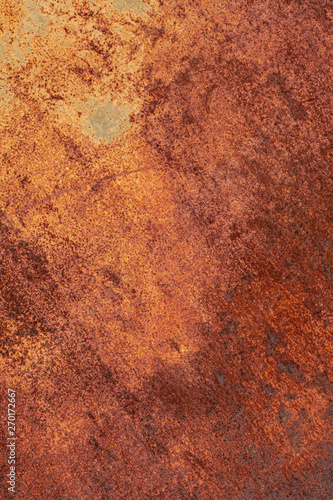 Rusty yellow-red textured metal surface. The texture of the metal sheet is prone to oxidation and corrosion. Textured background in grunge style