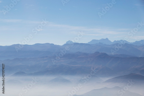 Misty blue Andean mountain landscape background © nomadkate
