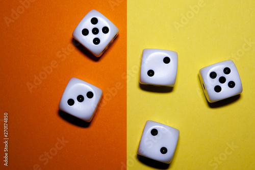 Dice flat lay on Yellow and orange background