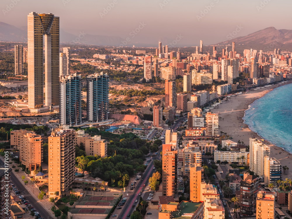 panoramic aerial view of the skyscrapers of the city of Benidorm, Alicante, Valencia, Spain and the beach of poniente , at sunset in summer