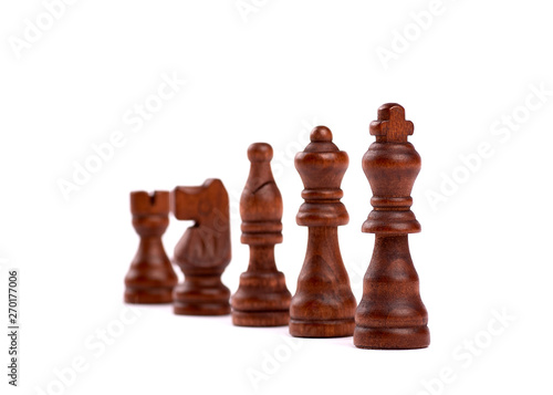 Row of black wooden chess pieces. Team Hierarchy With Defocused Background. Isolated On White Background.