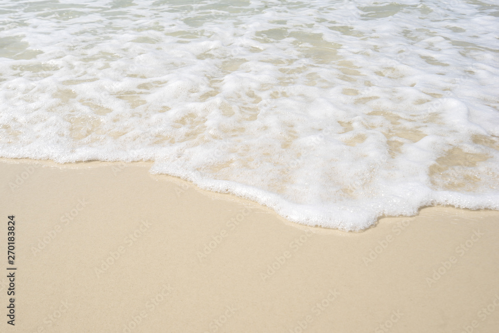 Soft wave of sea on the sandy beach.