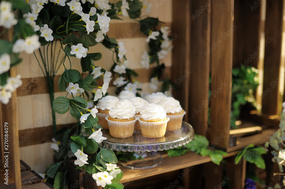 Delicious colorful wedding cupcakes with flower.