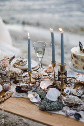 Sea wedding decor on the coast. Evening wedding ceremony near the water