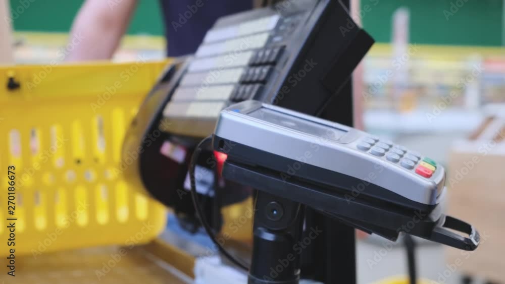 Supermarket: Checkout Counter Customer Pays with Smartphone for His Food Items. Big Shopping Mall Modern Wireless Paying Terminal System. Supermarket: Checkout Counter Customer Pays with Smartphone for His Food Items. Big Shopping Mall Modern Wireless Paying Terminal System.