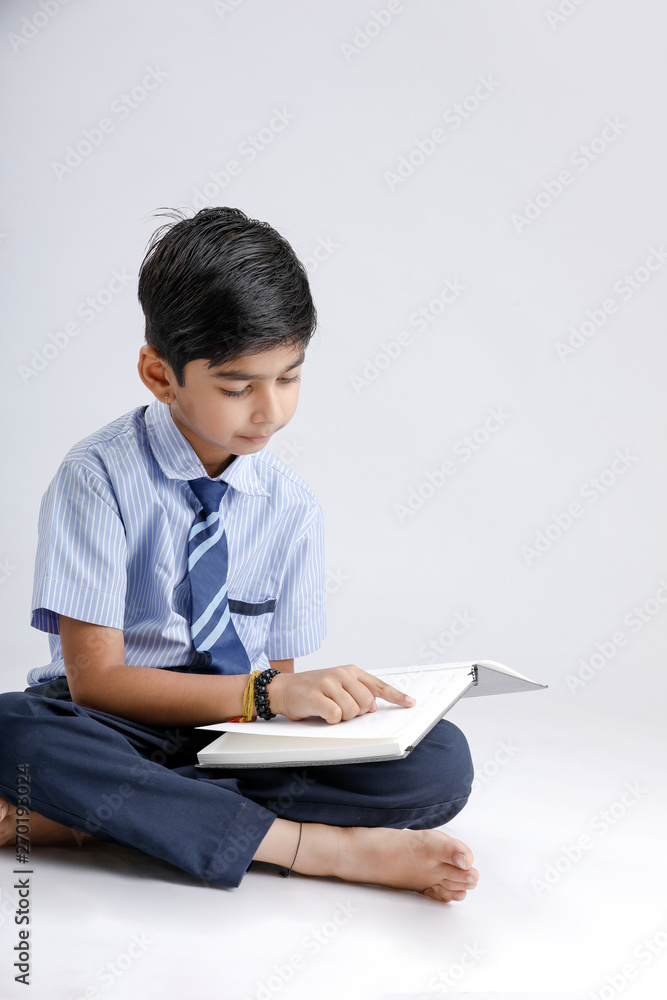 Indian / Asian school boy with note book and studying Indian / Asian school boy with note book and studying