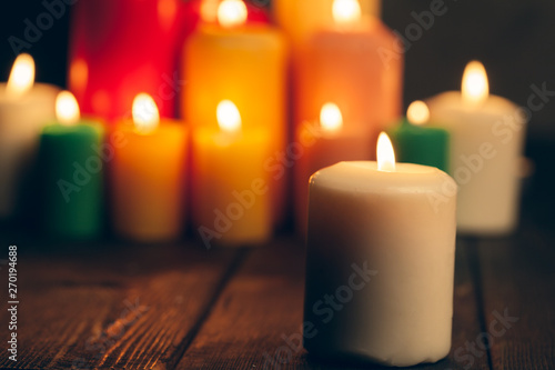 candles burning in darkness over black background. commemoration concept.