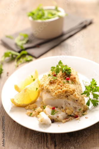 cooked fish with a crust and herbs