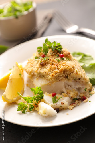 fish fillet cooked with crust , lemon and basil