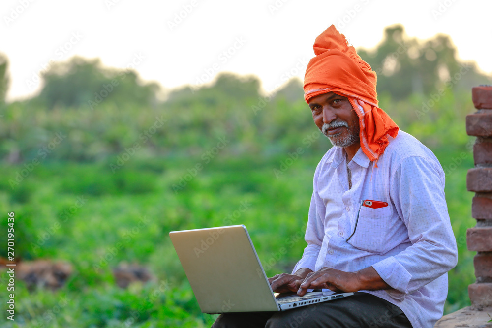 Indian rural farmer using laptop