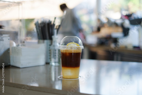 Iced americano coffee with soda ,lime  and orange juice on the table with selective focus. photo