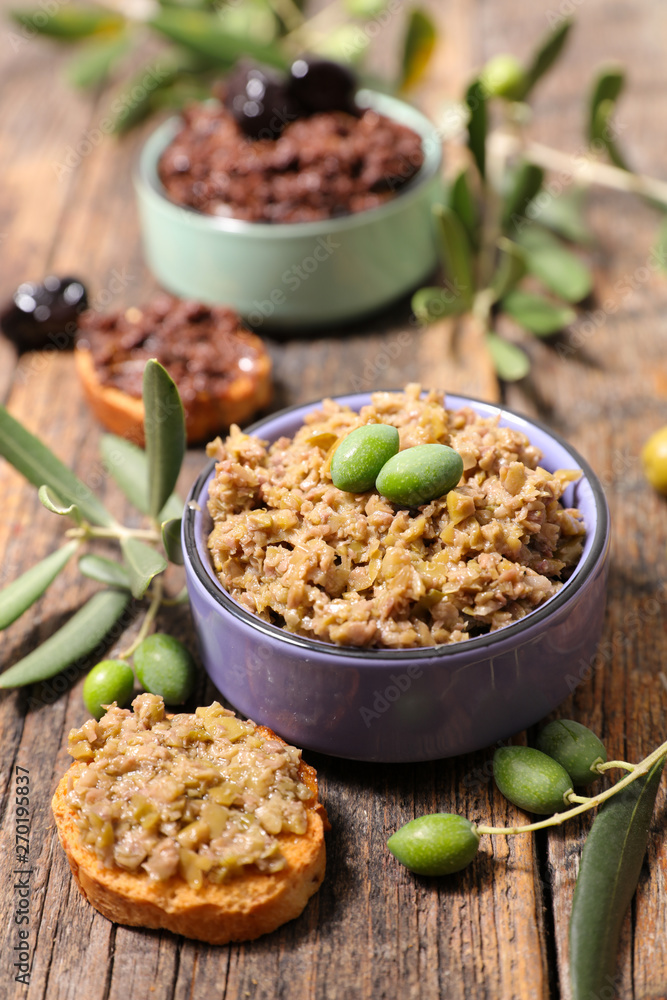 olive tapenade and toast on wood background olive tapenade and toast on wood background