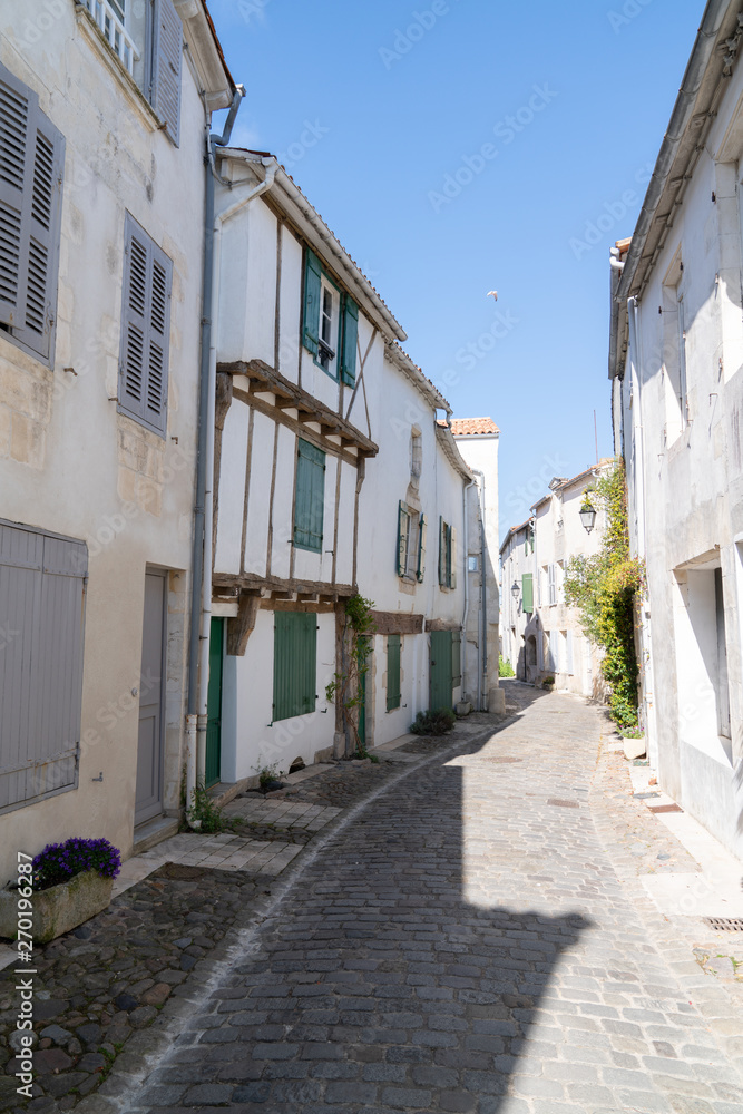 antique french cobblestone street in Saint Martin de Re, France