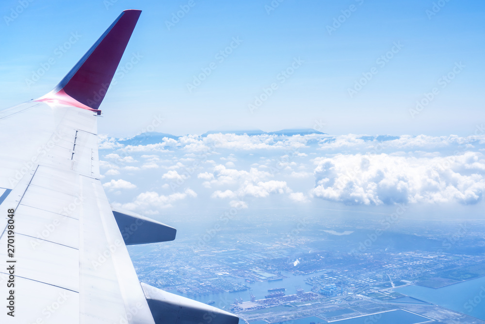 Bussiness and travel concept. Aerial view through window inside aircraft cabin with beautiful blue sky and cloud with sunlight, copy space, top view