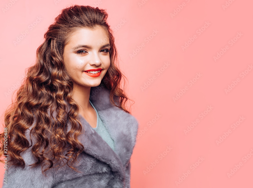 Maintaining natural volume. Pretty girl with curly hairstyle. Healthy hair care. Hair styling in hair salon. Young woman with long locks of hair. Teenage girl with stylish wavy hairstyle, copy space Stock Maintaining natural volume. Pretty girl with curly hairstyle. Healthy hair care. Hair styling in hair salon. Young woman with long locks of hair. Teenage girl with stylish wavy hairstyle, copy space Stock