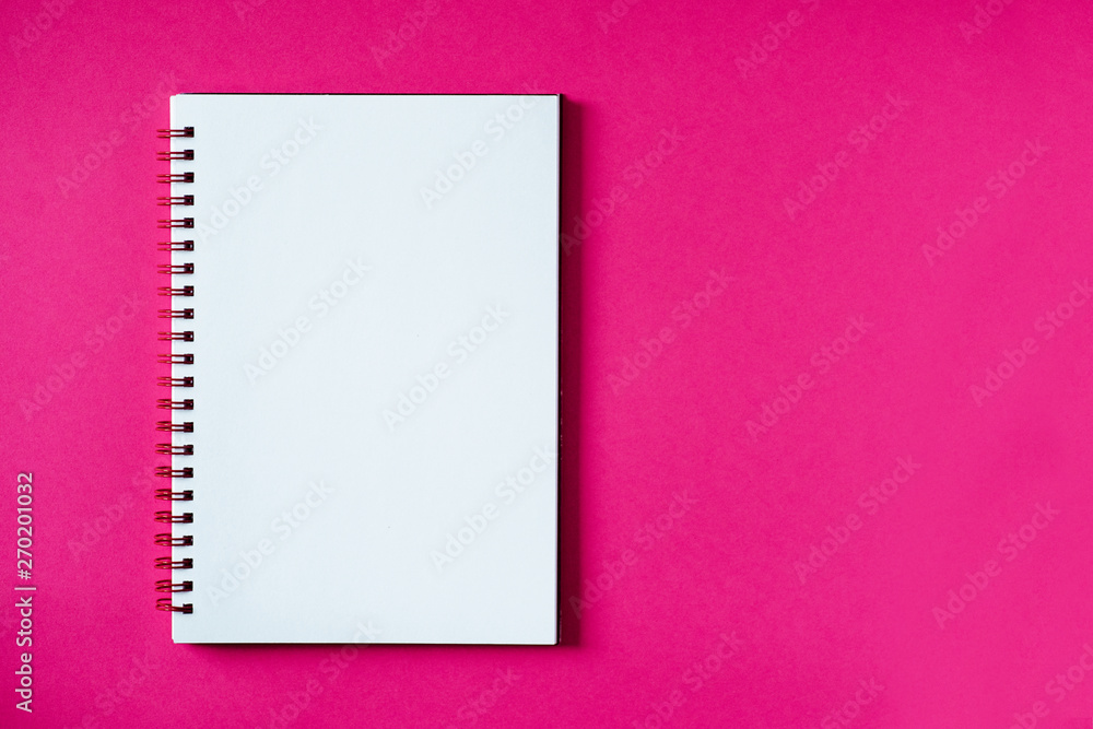 School notebook on a pink background, spiral notepad on a table. Top view copy space, mockup. Office notepad flat lay. School notebook on a pink background, spiral notepad on a table. Top view copy space, mockup. Office notepad flat lay.
