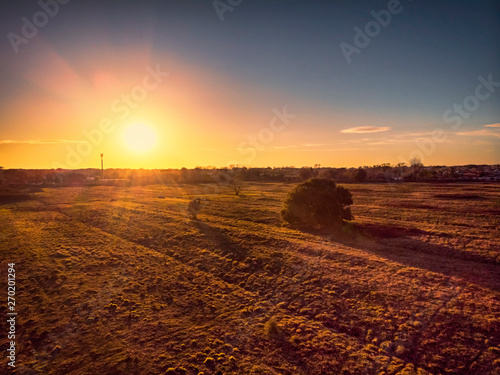 Amazing sunset aerial view up countryside above meadow and trees with relaxing atmosphere