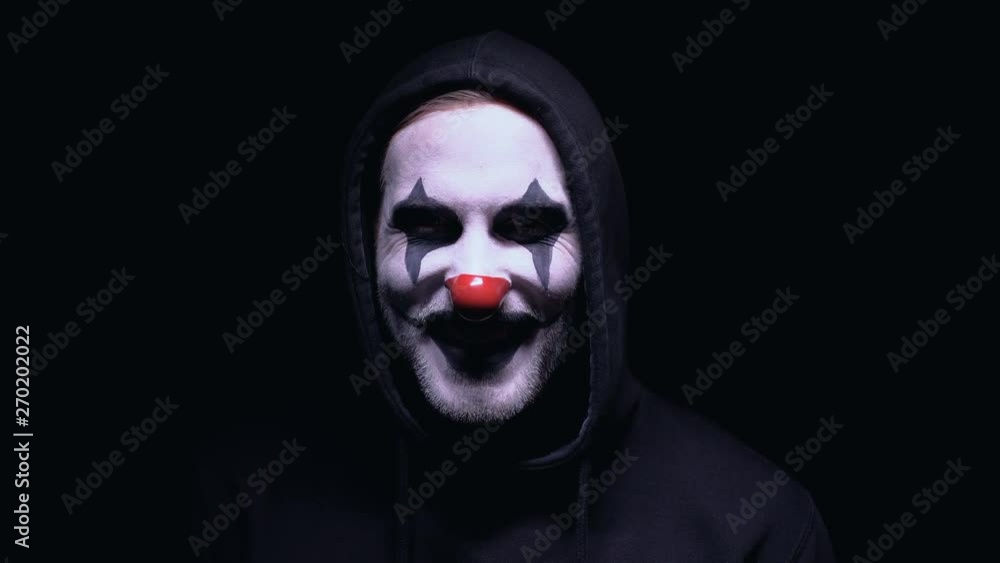 Insane man with clown face intimidating victim, mental disorder, nightmare Insane man with clown face intimidating victim, mental disorder, nightmare